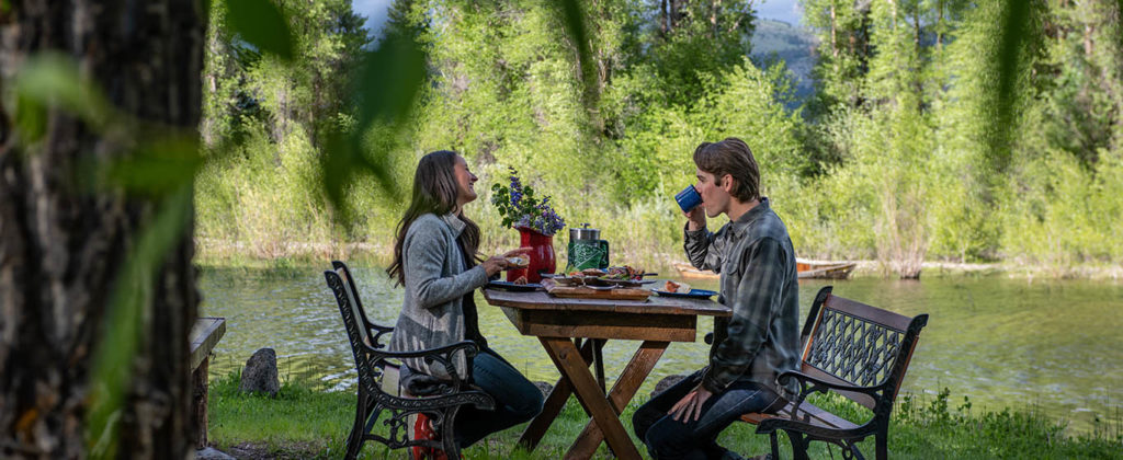 A Couple Enjoys A Gourmet Breakfast Outdoors Next To The Snake River In Jackson Hole Wyoming
