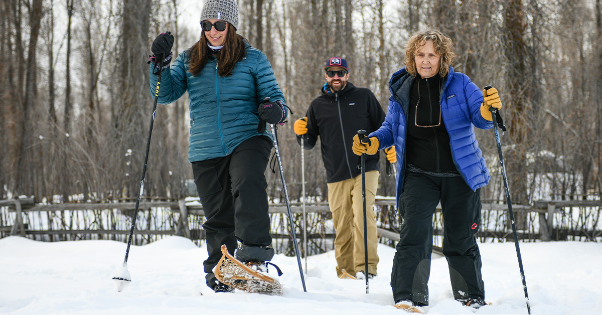Snowshoers Walk Over Snow At Tipi Camp In Jackson Hole Wyoming
