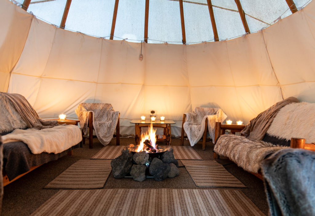 A Nice Fire Warms The Inside Of A Tipi, Set Up For Guests At Tipi Camp For Jackson Hole Vintage Adventures In Jackson Wyoming