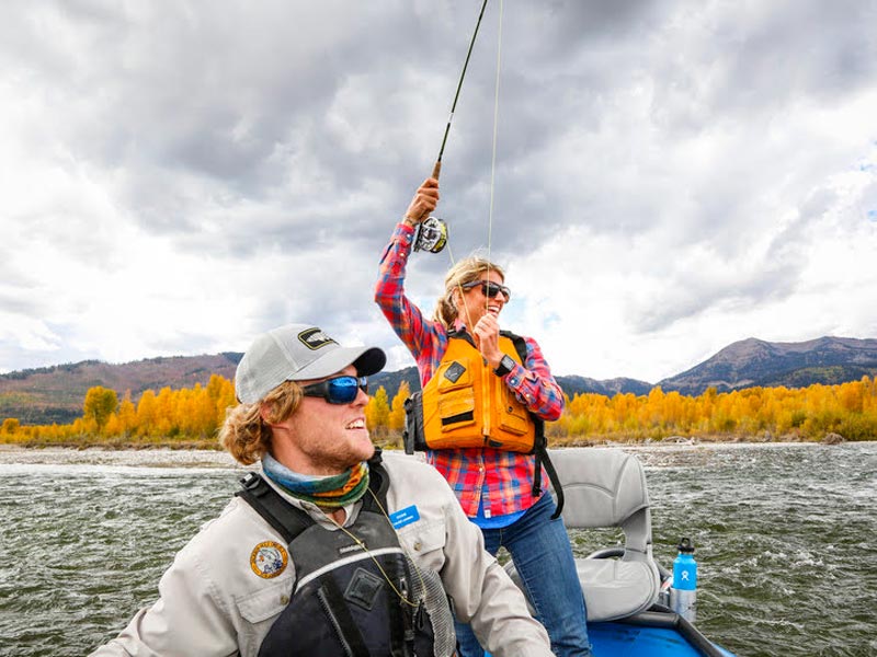 An Instructor Gives Feedback For A Fly Fishing Student While Rowing A Boat On The Snake River In Jackson Hole