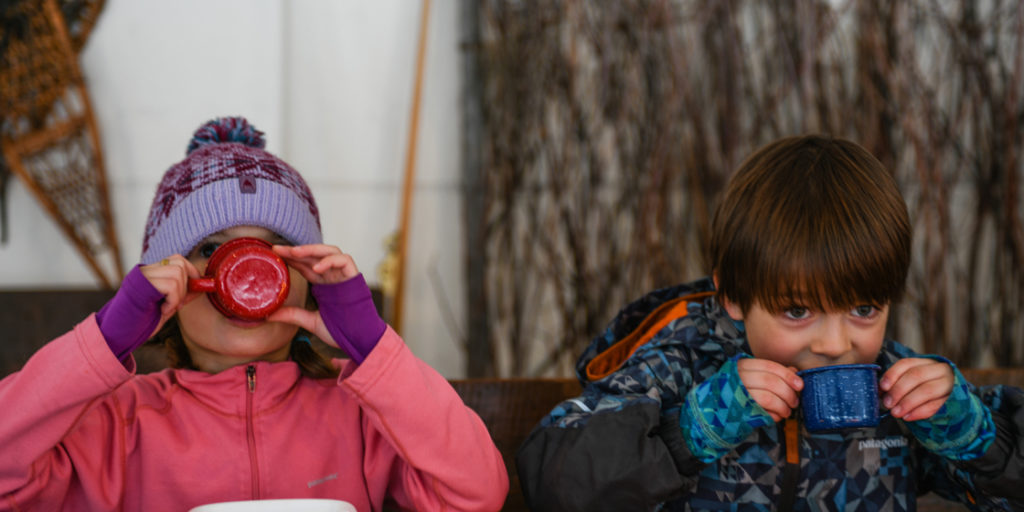 Kids Sip On Hot Cocoa Inside The Dining Tent At Tipi Camp With Jackson Hole Vintage Adventures In Jackson Hole