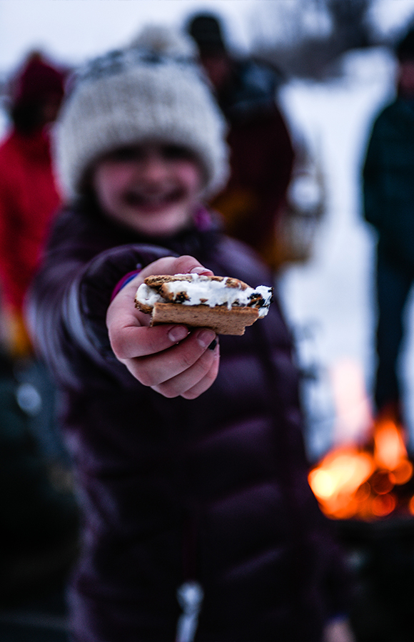 A Girl Holds Out A Melted S'More Treat, Freshly Made In The Campfire At Tipi Camp In Jackson Hole